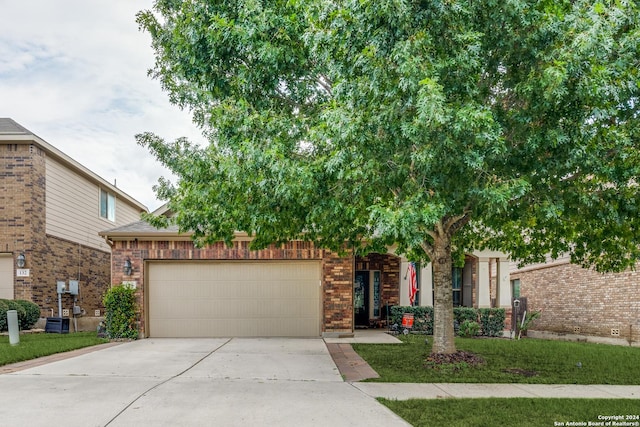 view of property hidden behind natural elements with concrete driveway, brick siding, a front lawn, and an attached garage