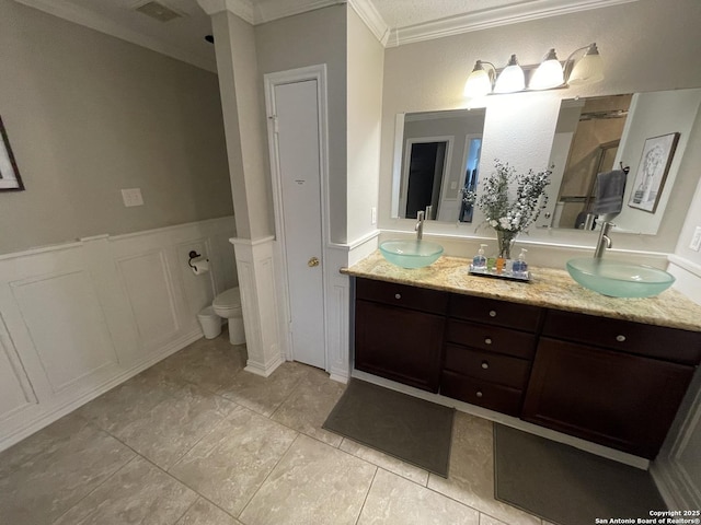 full bathroom featuring crown molding, visible vents, a sink, and double vanity