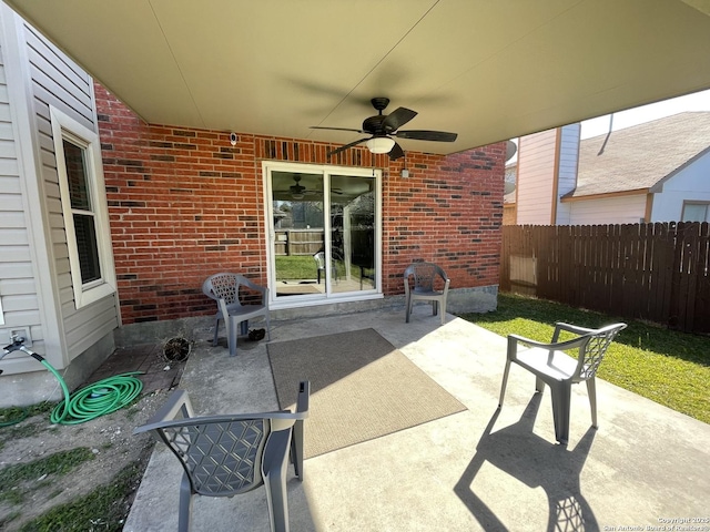 view of patio with fence and ceiling fan