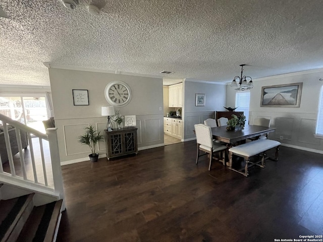 dining space featuring dark wood-style flooring, visible vents, and crown molding