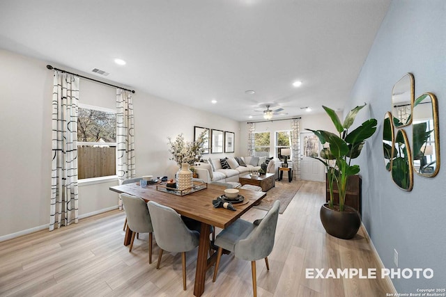 dining room featuring light wood-type flooring, baseboards, visible vents, and recessed lighting