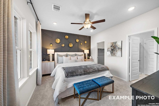 bedroom with baseboards, visible vents, a walk in closet, carpet floors, and recessed lighting