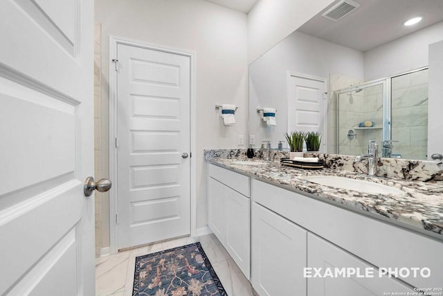 bathroom with a stall shower, visible vents, a sink, and double vanity