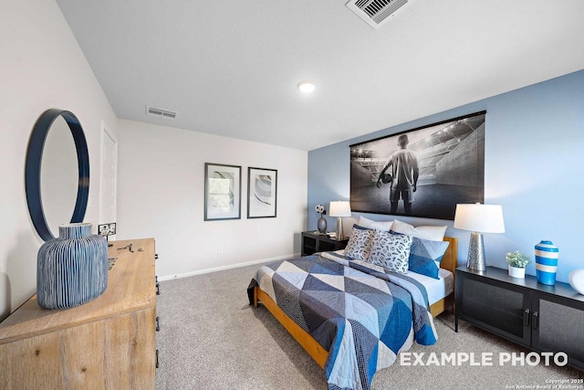 carpeted bedroom with visible vents and baseboards