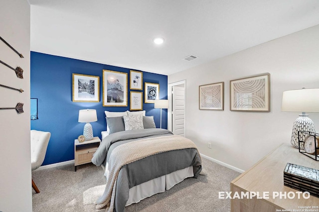 carpeted bedroom with visible vents and baseboards