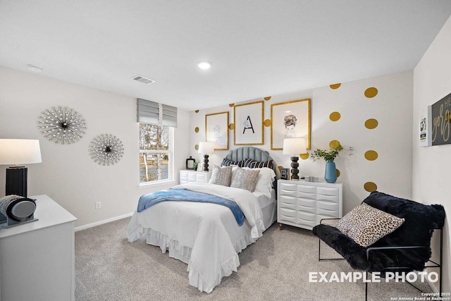 carpeted bedroom featuring visible vents and baseboards