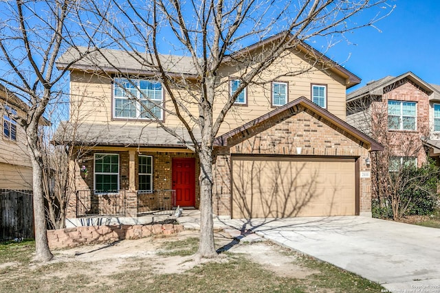 traditional home with brick siding, covered porch, and driveway