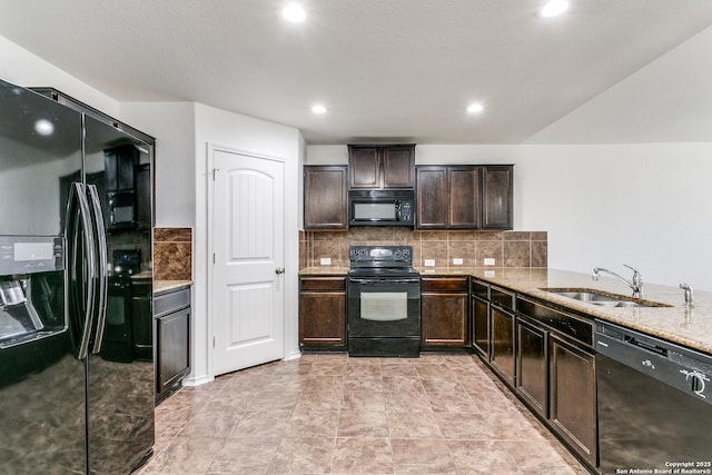 kitchen with black appliances, a sink, light stone counters, dark brown cabinetry, and decorative backsplash