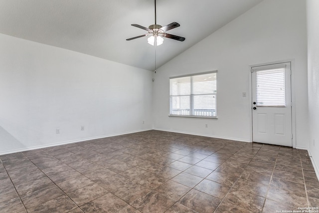 empty room with baseboards, high vaulted ceiling, and ceiling fan