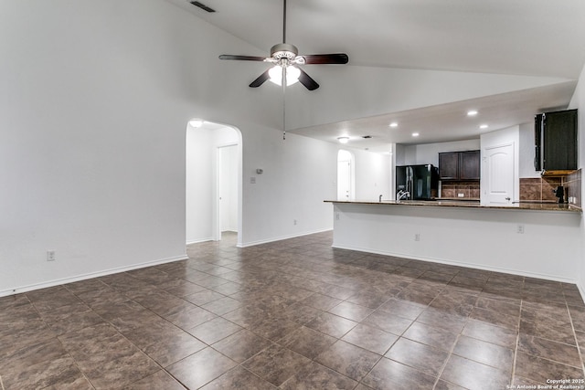 unfurnished living room featuring baseboards, recessed lighting, arched walkways, high vaulted ceiling, and a ceiling fan