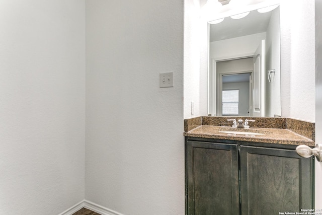 bathroom featuring vanity and baseboards