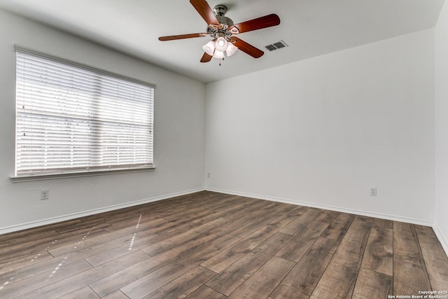 empty room featuring visible vents, ceiling fan, baseboards, and wood finished floors