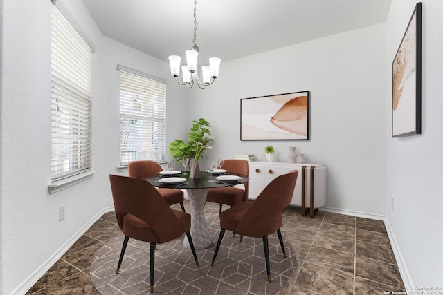 dining space featuring baseboards and a notable chandelier