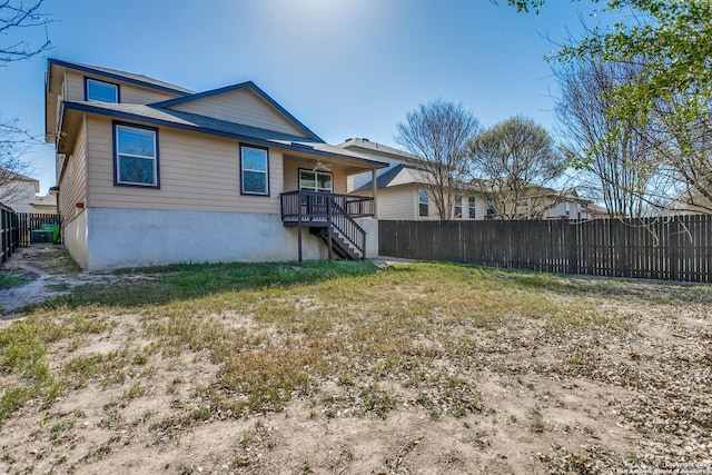 rear view of house with fence