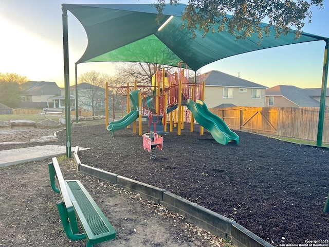 communal playground featuring fence