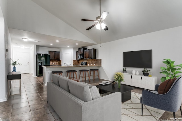 living area with tile patterned floors, high vaulted ceiling, a ceiling fan, recessed lighting, and baseboards