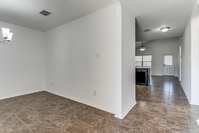 empty room with a ceiling fan, arched walkways, visible vents, and baseboards