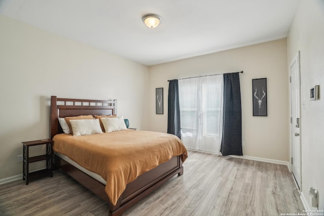 bedroom featuring light wood-style flooring and baseboards