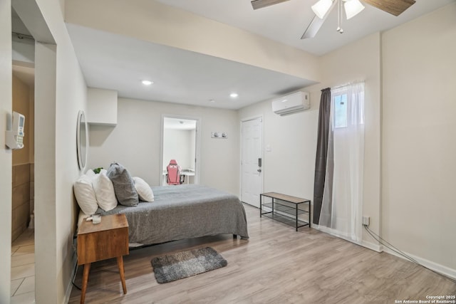 bedroom featuring ceiling fan, recessed lighting, light wood-style floors, and a wall mounted AC