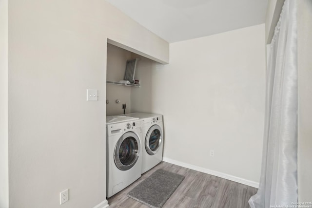 laundry room featuring laundry area, light wood-style floors, independent washer and dryer, and baseboards