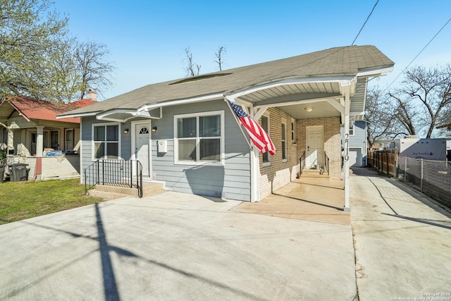 view of front of home featuring a carport, fence, driveway, and a chimney