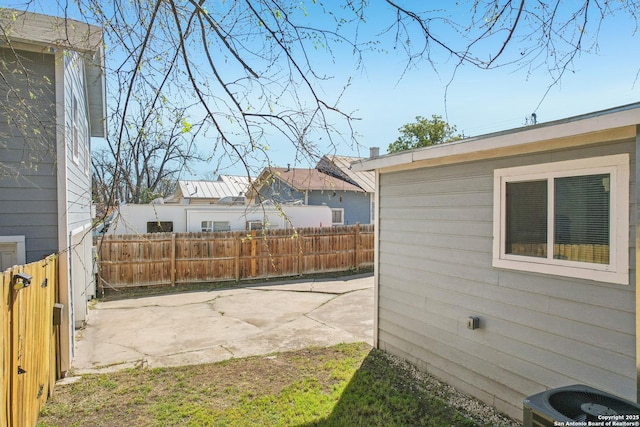 view of yard with a patio area, central AC, and fence