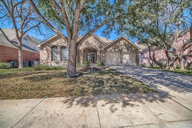 view of front of house with a garage, brick siding, driveway, and a front lawn