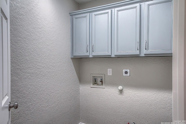 laundry room featuring cabinet space, a textured wall, hookup for a gas dryer, washer hookup, and electric dryer hookup