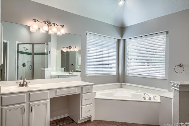 bathroom with a stall shower, a garden tub, vanity, and tile patterned floors