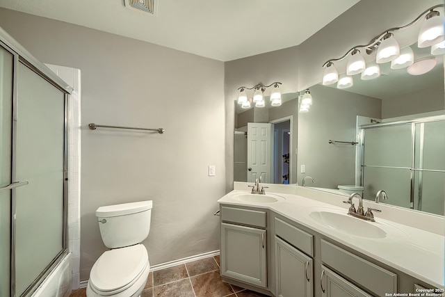 full bath featuring toilet, a sink, and tile patterned floors