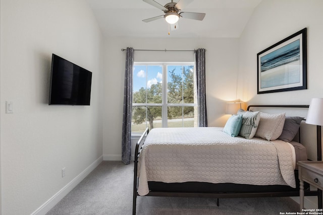 carpeted bedroom with a ceiling fan, lofted ceiling, and baseboards