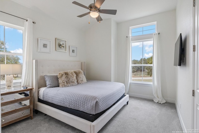 bedroom with baseboards, a ceiling fan, and light colored carpet