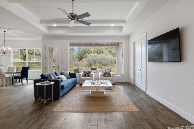 living area with a raised ceiling, baseboards, and dark wood-style flooring