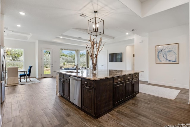 kitchen with dark wood-style flooring, a raised ceiling, an inviting chandelier, a sink, and dishwasher