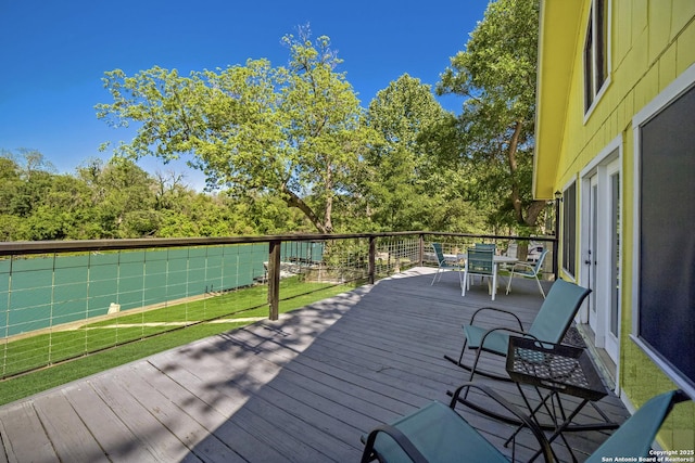 wooden deck with outdoor dining space