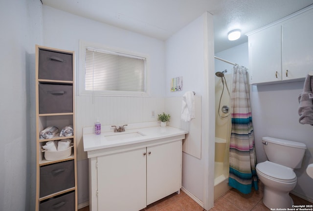 full bath with a shower with curtain, vanity, toilet, and tile patterned floors