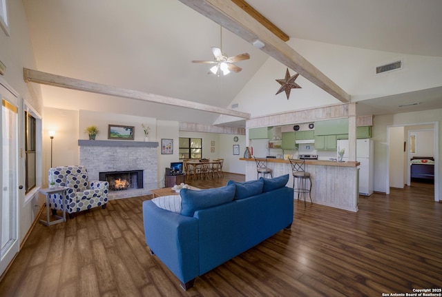living area featuring dark wood-style floors, a fireplace, visible vents, and beamed ceiling