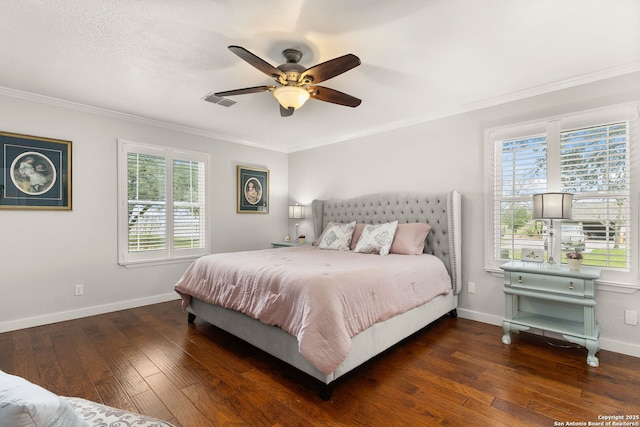 bedroom with ornamental molding, visible vents, baseboards, and hardwood / wood-style flooring