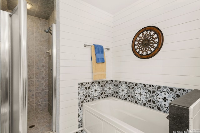 full bathroom featuring a stall shower and a bath