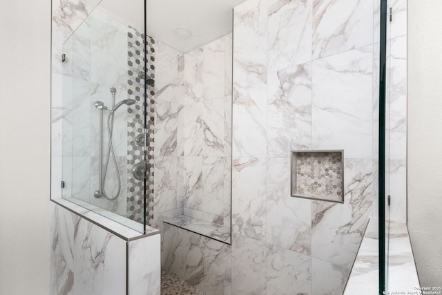 bathroom with a marble finish shower