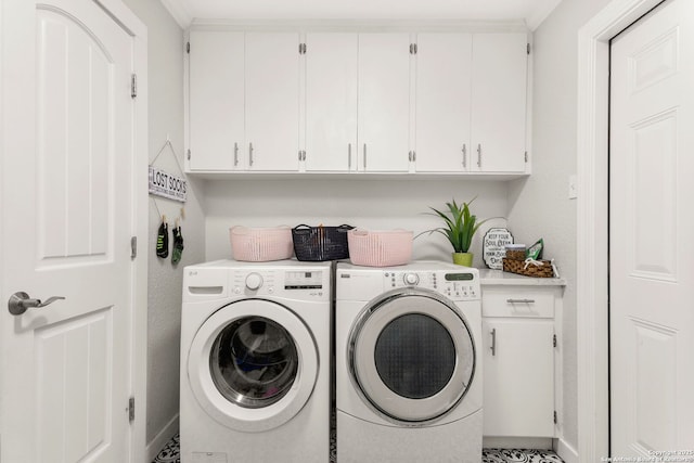 laundry area featuring washing machine and dryer and cabinet space