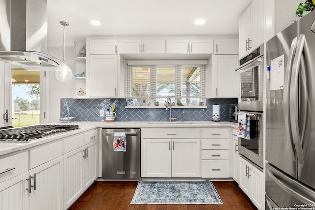 kitchen with stainless steel appliances, a sink, island range hood, and dark wood-style floors