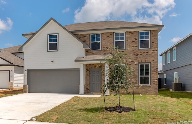 traditional-style house featuring a garage, concrete driveway, brick siding, and a front yard