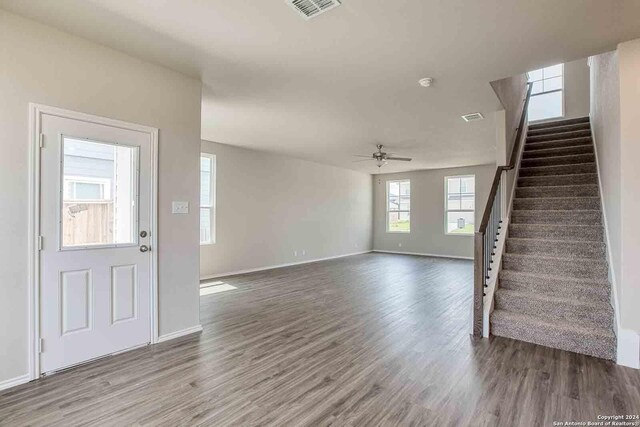 entryway with visible vents, a ceiling fan, wood finished floors, baseboards, and stairs