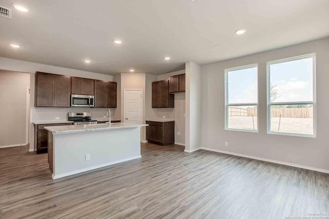 kitchen with appliances with stainless steel finishes, wood finished floors, and recessed lighting