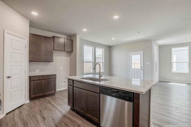 kitchen featuring dark brown cabinets, dishwasher, a sink, and wood finished floors