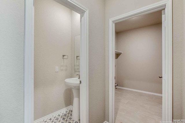 bathroom with baseboards and a sink