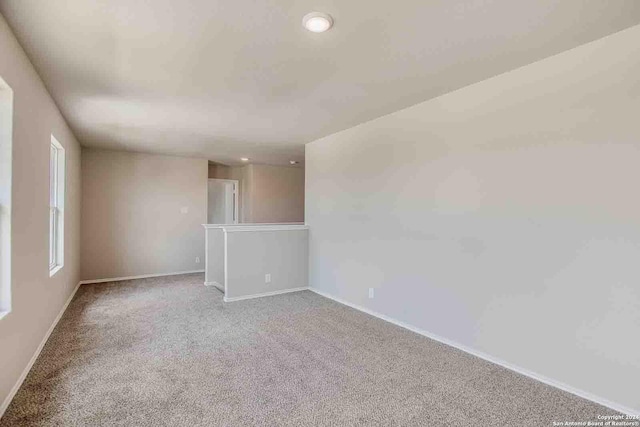 carpeted spare room with baseboards