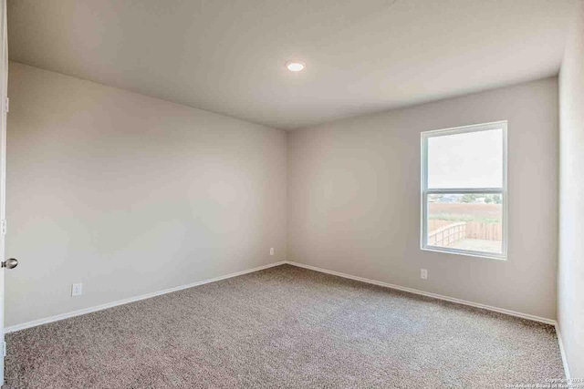 carpeted spare room with baseboards and recessed lighting