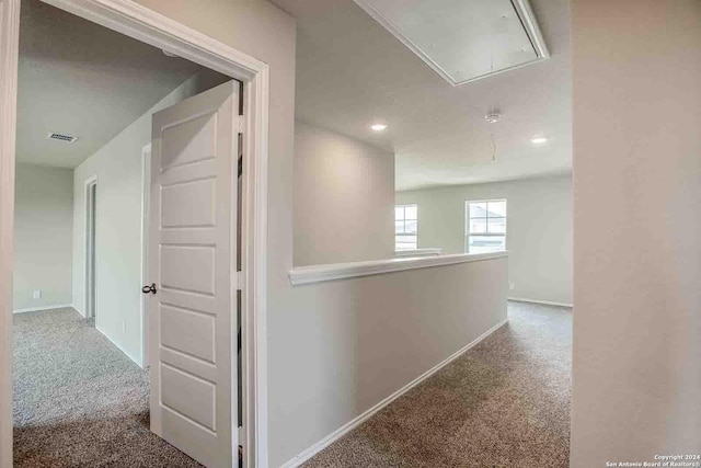 corridor with recessed lighting, carpet floors, visible vents, baseboards, and attic access